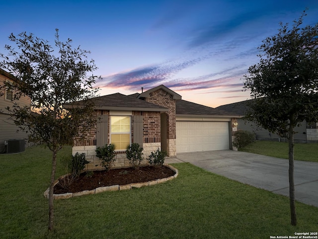 single story home with a yard, a garage, and central air condition unit