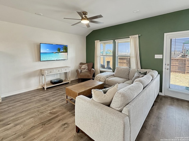 living room with vaulted ceiling, a healthy amount of sunlight, hardwood / wood-style floors, and ceiling fan