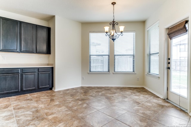 unfurnished dining area with light tile patterned flooring and an inviting chandelier