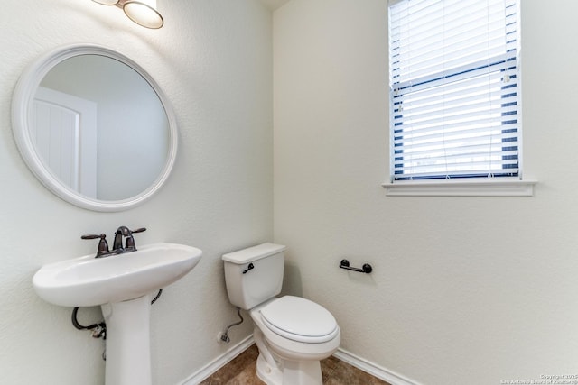 bathroom with tile patterned flooring and toilet