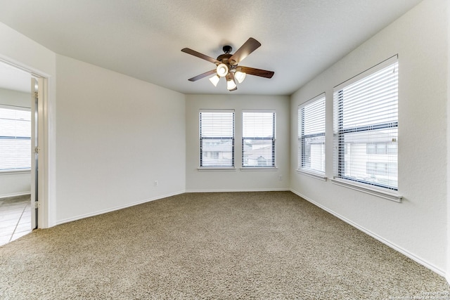 spare room featuring ceiling fan, carpet flooring, and a textured ceiling