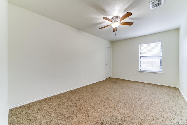 unfurnished room with a textured ceiling, ceiling fan, and carpet flooring