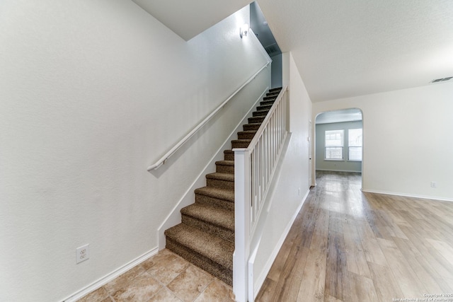 stairway featuring hardwood / wood-style flooring