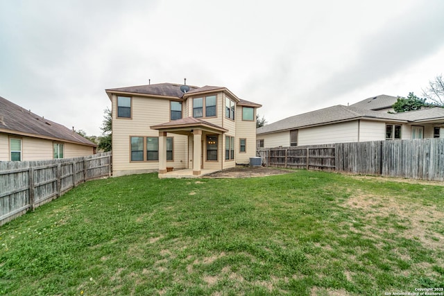 back of house with cooling unit, a lawn, and a patio area