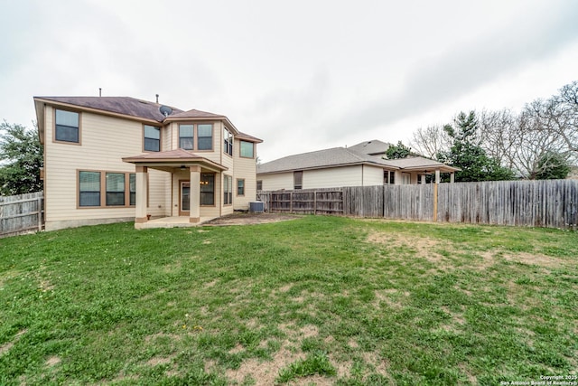 back of property featuring central air condition unit, a patio, and a lawn