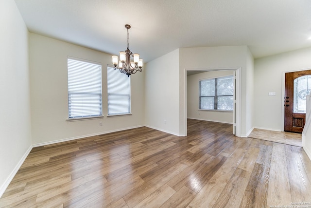 foyer featuring a notable chandelier and light wood-type flooring