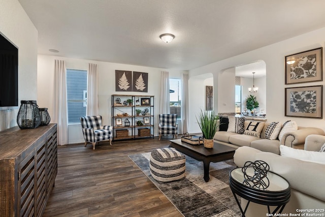 living room featuring dark hardwood / wood-style floors and a chandelier