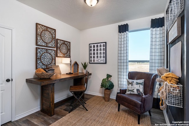 office area with dark wood-type flooring and a textured ceiling