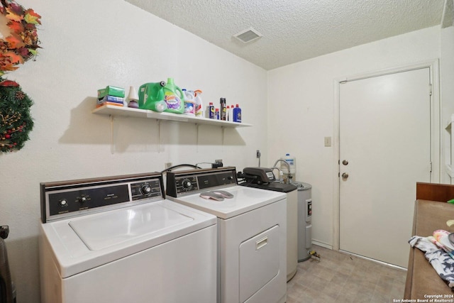 washroom featuring separate washer and dryer and a textured ceiling