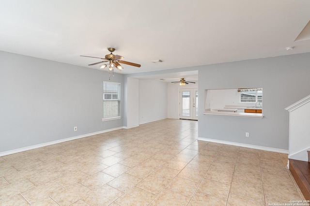 spare room with ceiling fan and light tile patterned floors