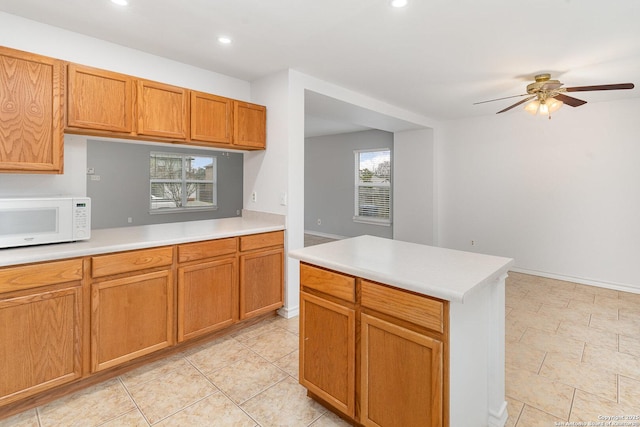 kitchen featuring ceiling fan and light tile patterned flooring