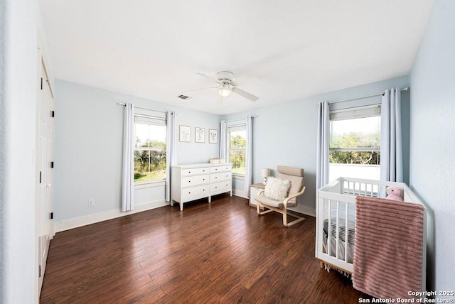 sitting room featuring dark hardwood / wood-style flooring, a wealth of natural light, and ceiling fan