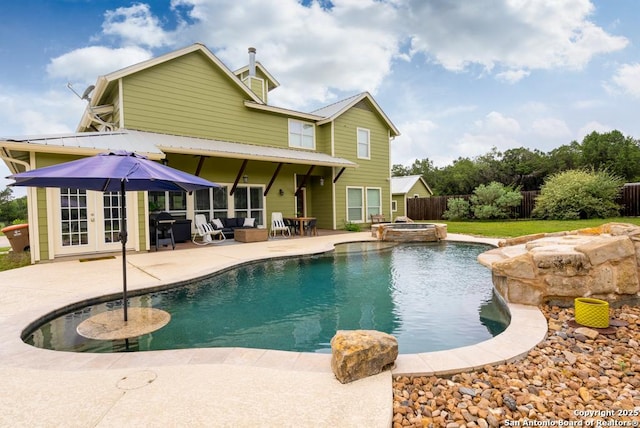 view of pool featuring an in ground hot tub, a patio, and french doors