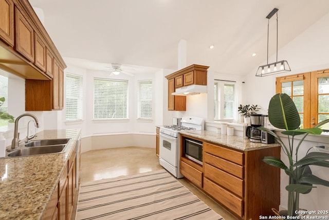 kitchen with sink, gas range gas stove, vaulted ceiling, stainless steel microwave, and pendant lighting