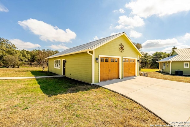 garage with a yard and central AC