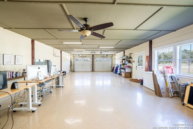 garage with a wall mounted air conditioner and ceiling fan