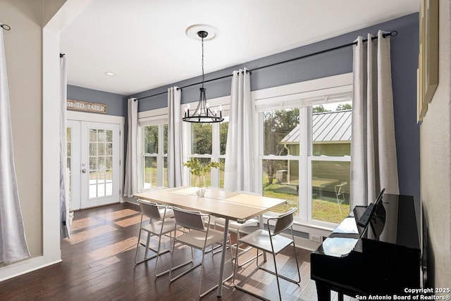 dining room featuring a chandelier, dark hardwood / wood-style flooring, and french doors