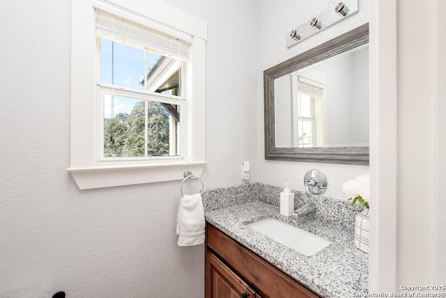 bathroom with plenty of natural light and vanity