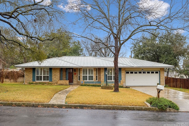 ranch-style home with a garage and a front yard