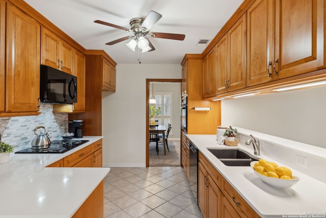 kitchen featuring sink, light tile patterned floors, ceiling fan, black appliances, and decorative backsplash