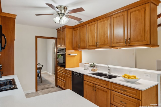 kitchen featuring sink, light tile patterned floors, ceiling fan, and black appliances