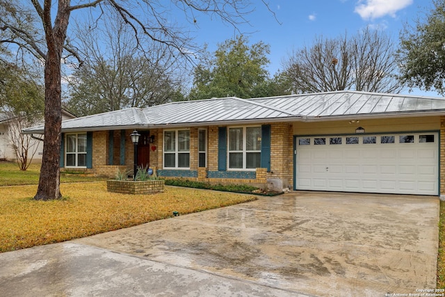 ranch-style house featuring a garage and a front lawn