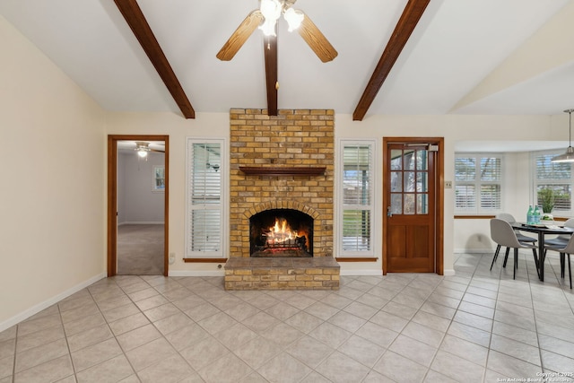 unfurnished living room with lofted ceiling with beams, ceiling fan, light tile patterned floors, and a fireplace