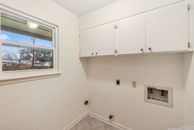 laundry room with cabinets, hookup for a gas dryer, light tile patterned floors, hookup for a washing machine, and hookup for an electric dryer