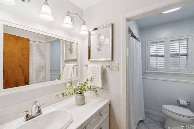 bathroom featuring tile patterned flooring, vanity, and toilet