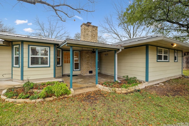 view of front of house with a patio area and a front yard