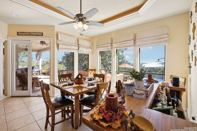 sunroom / solarium with ceiling fan and a tray ceiling