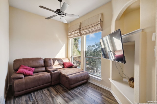 living room with dark wood-type flooring and ceiling fan