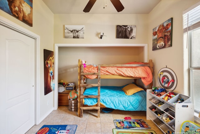 tiled bedroom with ceiling fan