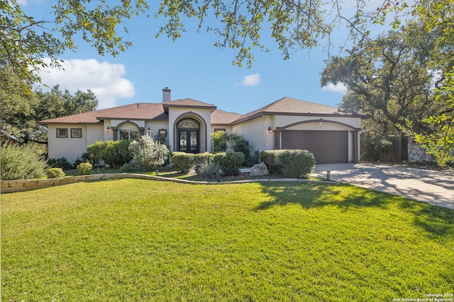 mediterranean / spanish home with a garage, a front yard, and french doors