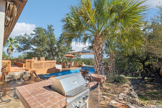 view of patio with a grill and an outdoor kitchen