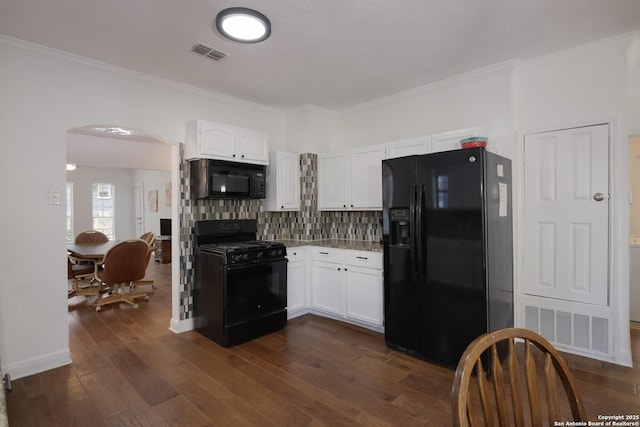 kitchen featuring white cabinetry, decorative backsplash, dark wood-type flooring, and black appliances