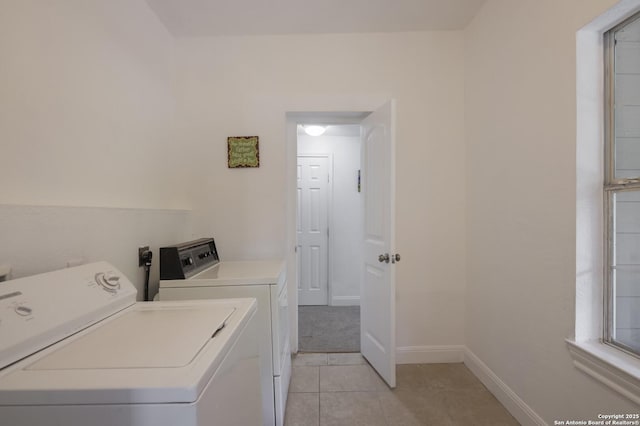 washroom featuring light tile patterned flooring and separate washer and dryer