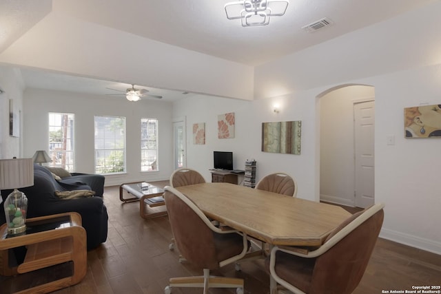 dining area with dark wood-type flooring and ceiling fan