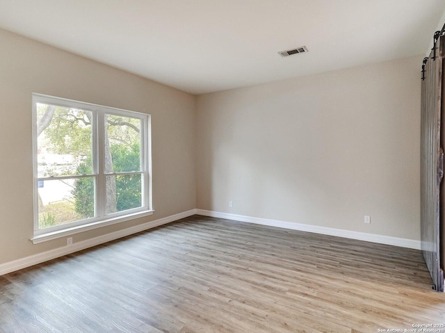 unfurnished room with light wood-type flooring