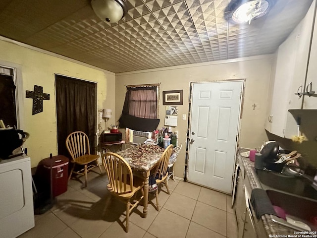 tiled dining space featuring washer / clothes dryer