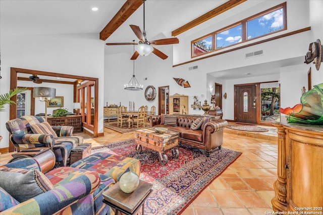 living room with beamed ceiling, a towering ceiling, and ceiling fan with notable chandelier