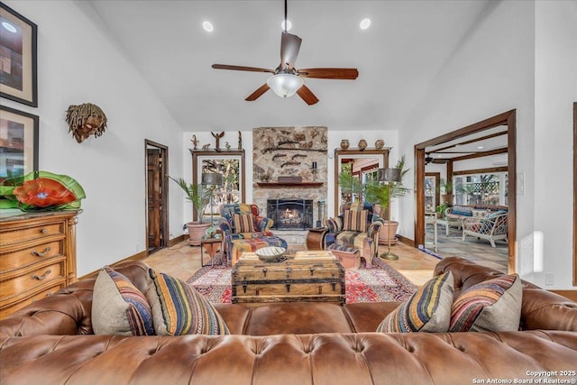 living room featuring high vaulted ceiling, a fireplace, and ceiling fan