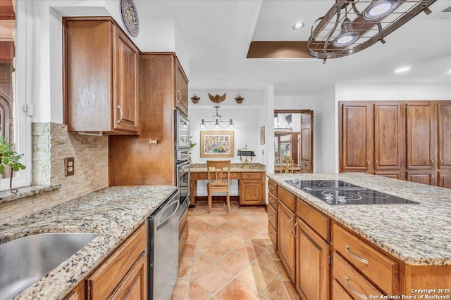 kitchen with light tile patterned flooring, appliances with stainless steel finishes, decorative backsplash, hanging light fixtures, and light stone counters