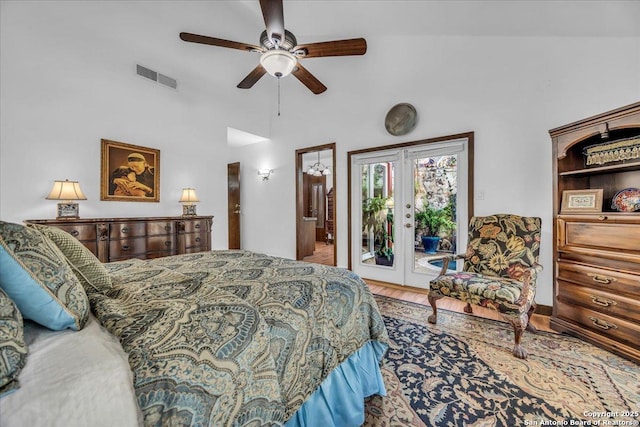 bedroom featuring hardwood / wood-style flooring, ceiling fan, access to exterior, a high ceiling, and french doors