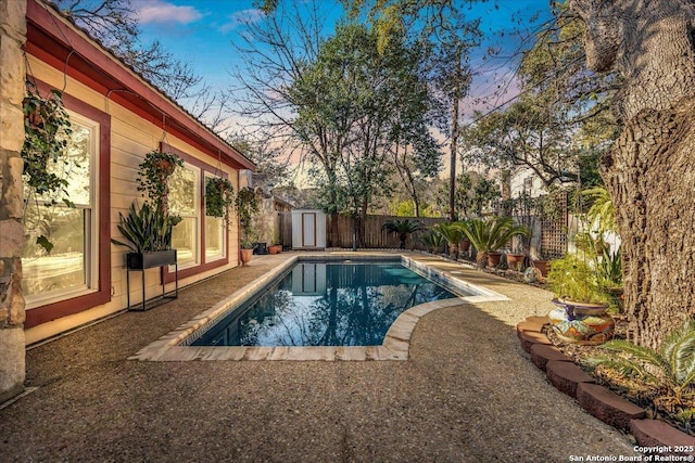 pool at dusk featuring a storage unit