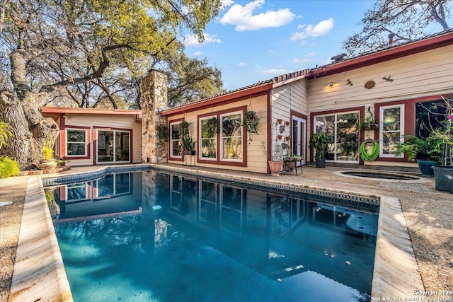 view of pool with a jacuzzi