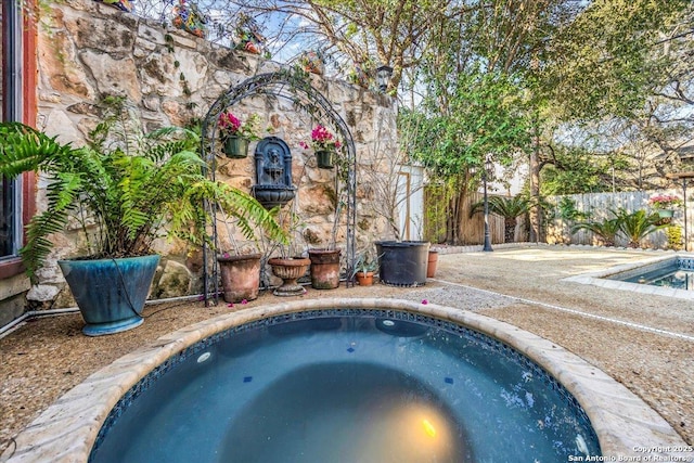 view of swimming pool featuring an in ground hot tub and sink