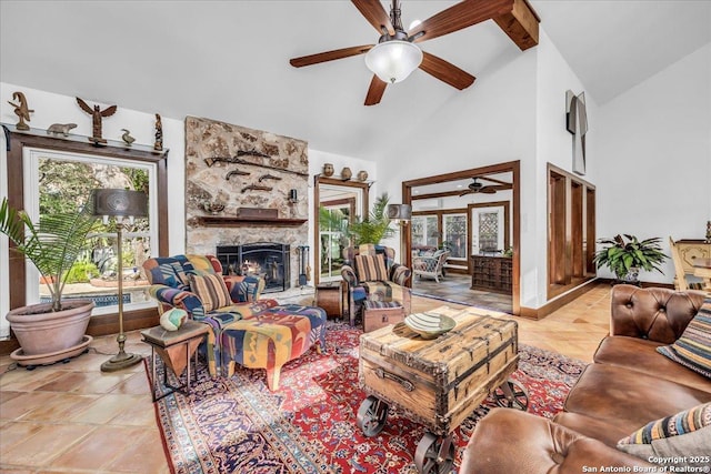 tiled living room with a stone fireplace, high vaulted ceiling, and ceiling fan