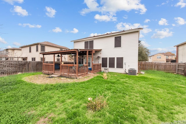 rear view of property with a wooden deck, a jacuzzi, central AC, and a lawn