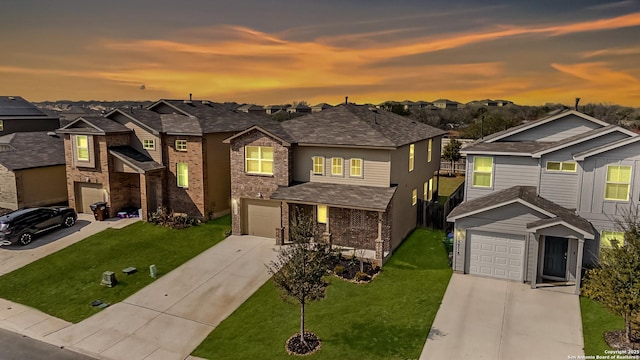 view of front of home with a garage and a lawn